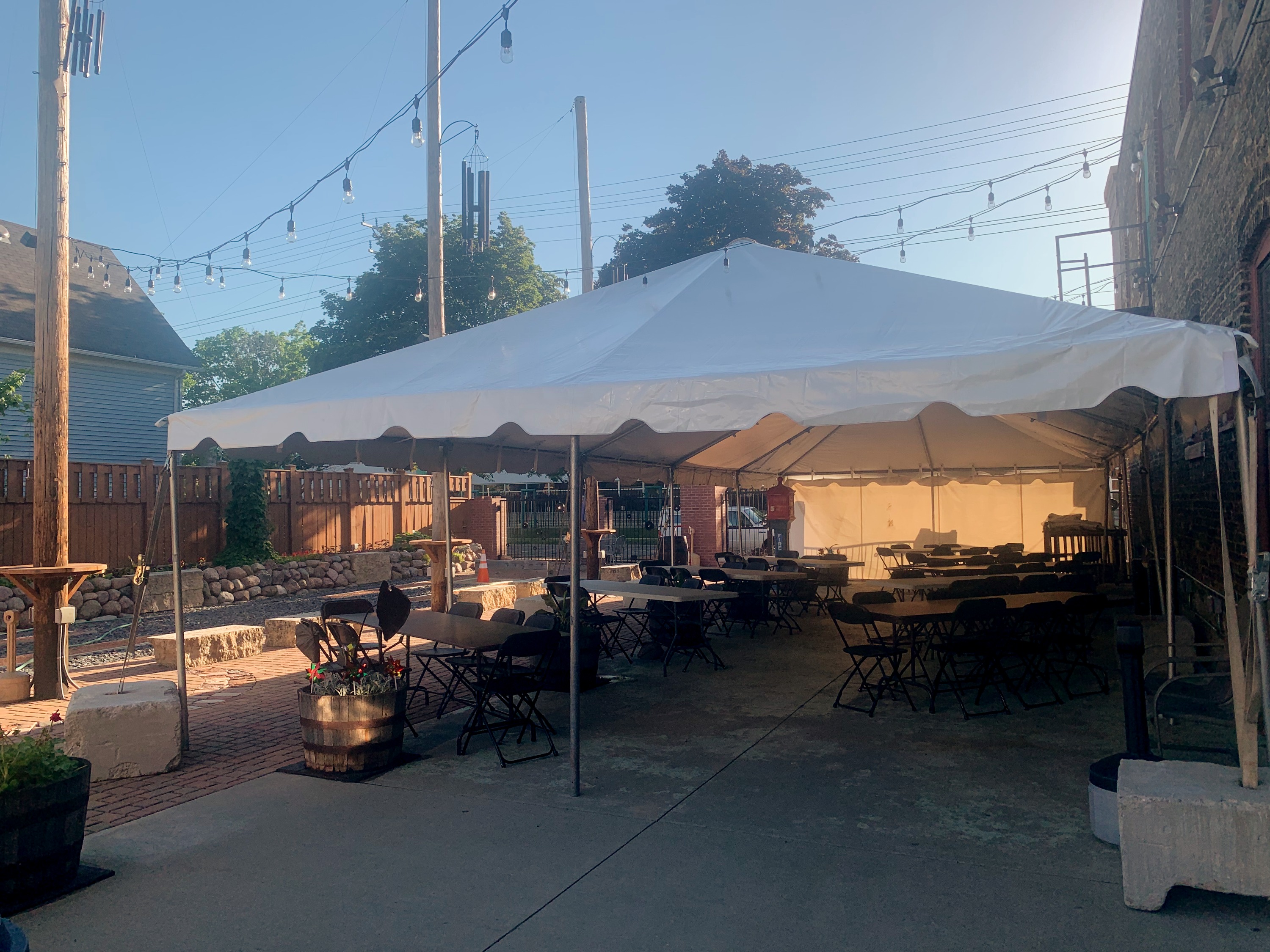 White event tent with flexible table seating in Kochanski's beer garden