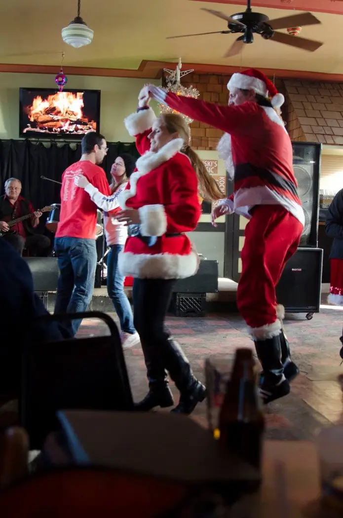 Guests in Santa costumes dancing inside Kochanski’s during the 2015 Santa Rampage